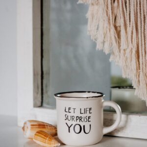 white ceramic mug on brown wooden table