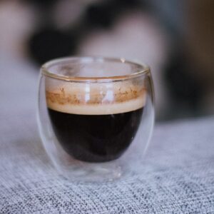 a cup of coffee sitting on top of a table