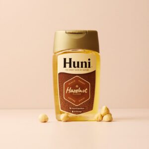 Bottle of huni hazelnut syrup with hazelnuts