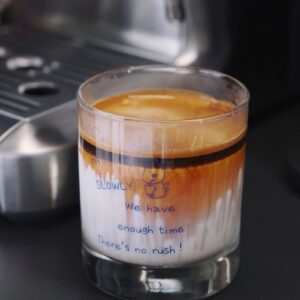 a glass of liquid sitting on top of a counter